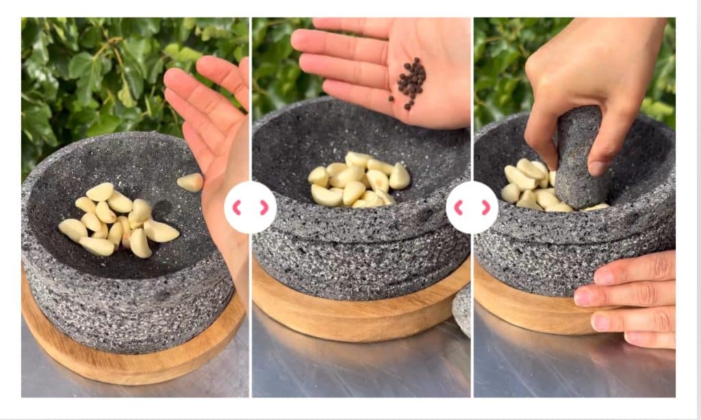 Molcajete Garlic Paste for Mojo de Ajo Garlic, peppercorns, salt, and olive oil being prepared in a molcajete for mojo de ajo