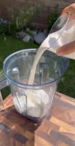 Pouring heavy cream into blender for fresas con crema.