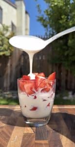 Cream mixture poured over fresh strawberries.