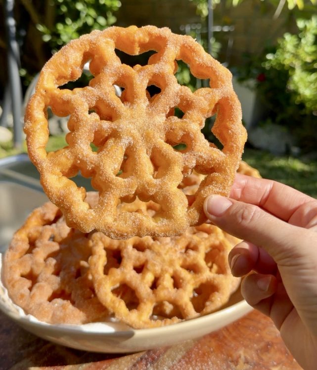 Golden, crispy Mexican buñuelos de viento sprinkled with cinnamon sugar.