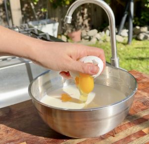 Eggs cracked into milk and whisked to create the wet mixture.