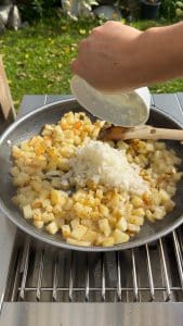 Diced onion added to skillet after potatoes start to crisp
