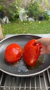 Guajillo-coated rolls frying in a skillet with oil