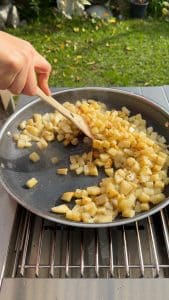 Potatoes cooking in an even layer to brown and crisp
